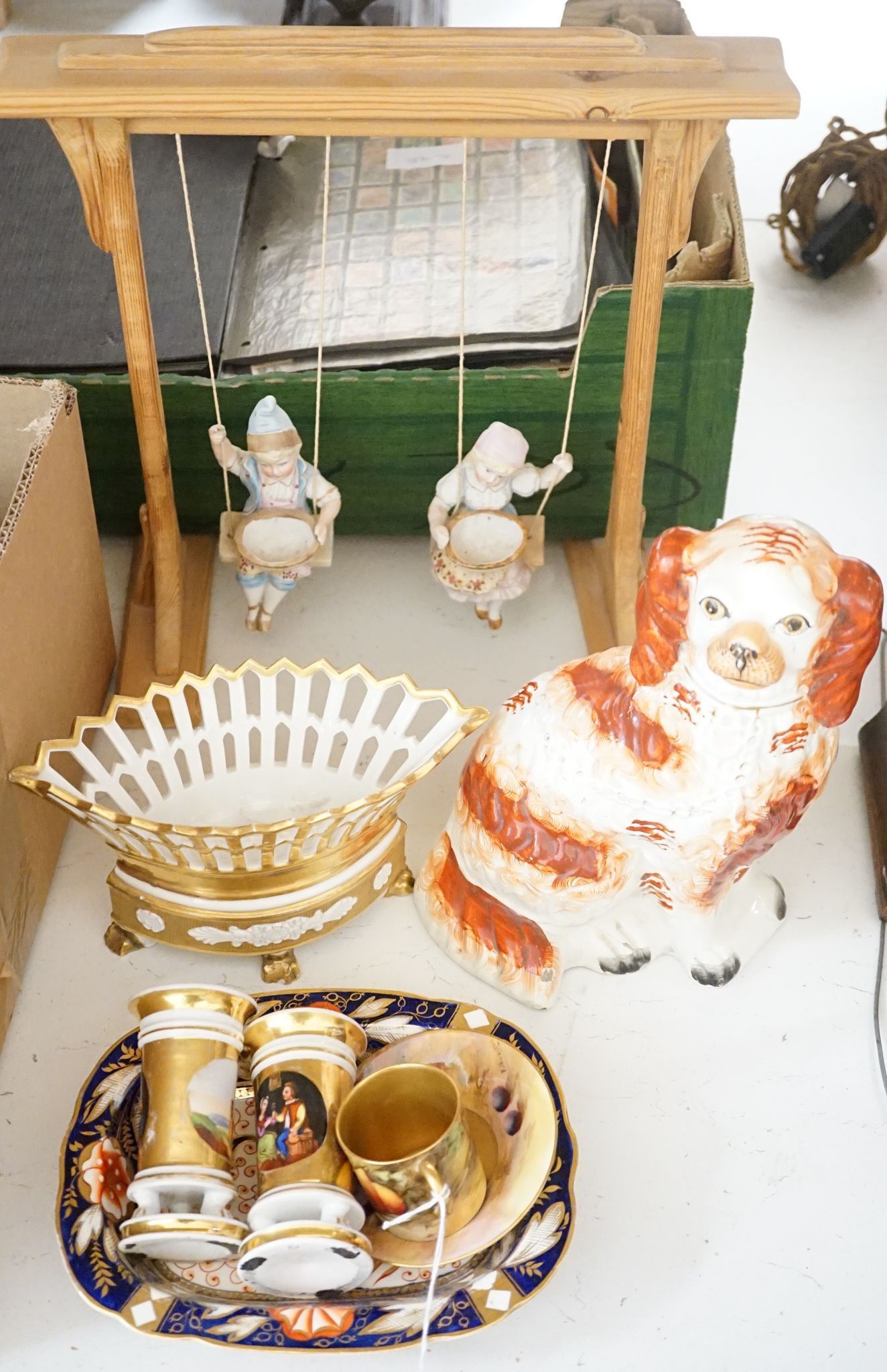 A pair of bisque swinging figures, Royal Worcester cabinet cup and saucer and five other items